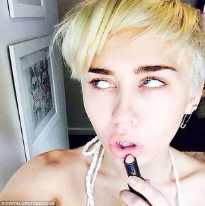 Miley Cyrus 2014 Porn Fakes - Miley Cyrus snaps her tattoos and sideboob while larking around in her huge  wardrobe | Daily Mail Online