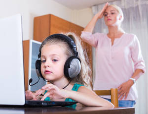 Littl Girl Looking At - Little girl playing computer game