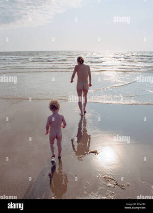 beach mother naked - mother and son going for a nude swim in the sea by Aberdyfy Aberdovey North  West Wales Stock Photo - Alamy