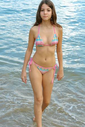 bikini on beach laying down - She likes het bikini to much.