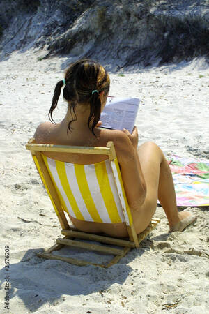 beach nude girls - Nude girl reading on beach Stock Photo | Adobe Stock
