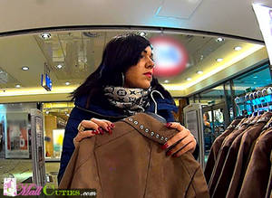 brunette chick in a mall - Brunette girl selecting some clothes