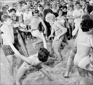 1960s Fraternity Party - 1960's dancing the twist on the beach. It looks more like a limbo to me