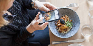Amazing Food Porn - Woman taking a photo of food on her phone