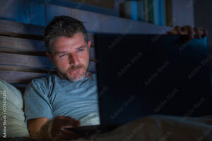cyber sex movie - man alone in bed playing cybersex using laptop computer watching porn sex  movie late at night with lascivious pervert face expression in internet  pornographic sexual content Stock Photo | Adobe Stock