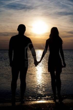 couple fuck on beach silhouette - Young Couple Silhouette On A Sea Beach Holding Hands And Looking.. Royalty  Free Stock