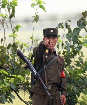 North Korean Army Porn - A North Korean soldier points at visitors near the North Korean town of  Sinuiju, opposite