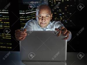 Black Man Watching Porn - addict businessman alone at night sitting at office computer laptop watching  porn or online gambling isolated