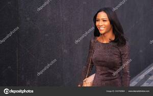 asian ladyboy forced - A beautiful slender Asian girl Ladyboy is walking on the background of a  black wall outside. Thai transgender model. Stock Photo by Â©kopitin  243792864