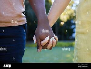interracial couples holding hands - Interracial hand holding couple hi-res stock photography and images - Alamy