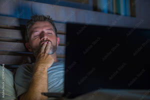 Facial Sleeping - man alone in bed playing cybersex using laptop computer watching porn sex  movie late at night with lascivious pervert face expression in internet  pornographic sexual content Stock Photo | Adobe Stock