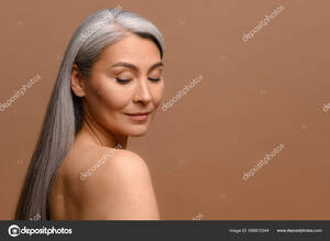 mature korean wife nude - Headshot of attractive middle-aged Asian woman with naked shoulders and  long silver hair Stock Photo by Â©VadymPastukh 566815344