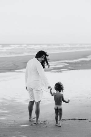 ebony nudist beach gallery - Woman and Nude Toddler Walking at the Beach Â· Free Stock Photo