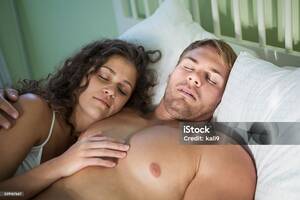 couples posing nude nudists - Young Couple Sleeping Together Lying In Bed Stock Photo - Download Image  Now - Hands On Chest, Women, 20-24 Years - iStock
