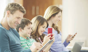 Cild Banned Family Porn - A mother and father on their phones with children