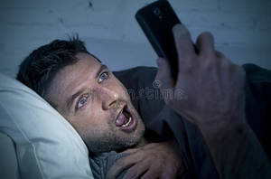 Home Porn Youngest - Download Man In Bed Couch At Home Late At Night Using Mobile Phone In Low  Light