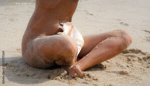 beach nude girls - naked girl in the sand with a big oceanic seashell on the beach Stock Photo  | Adobe Stock
