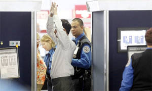 Airline Strip Search Porn - An airline passenger under goes a full-body scan at O'Hare International  Airport, 17 November 2010, in Chicago. Photograph: AP Photo/Charles Rex  Arbogast