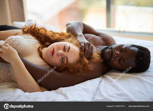 interracial couples sleeping - Beautiful interracial couple sleeping together on bed Stock Photo by  Â©romanchazov27 425527810